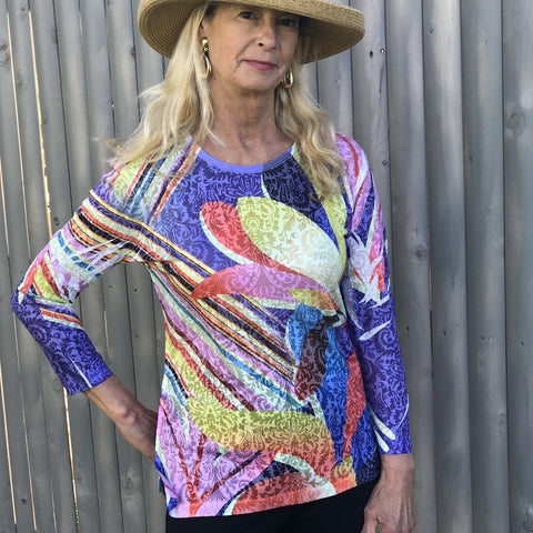 Very light and comfortable bright t-shirt with a high low and a round neck cut with a slit on each side for added comfort.  Polyester/Rayon Blend  Machine Wash Cold by two b's accessories