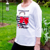 Fun fashion top. It is simply a conversation piece. Not only the front has a story but the back has a black ribbon that can be tied or not. This will add an accent especially with short hair. By Ravel