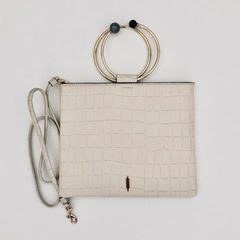 Ivory Le Pouch  embossed croco leather clutch with beaded  ring handle.  Elegant and practical when our hands are needed. It has a shoulder strap and can be used as a cross body.  Italian leather  10"W x 8"H by two b's accessories  and thacker